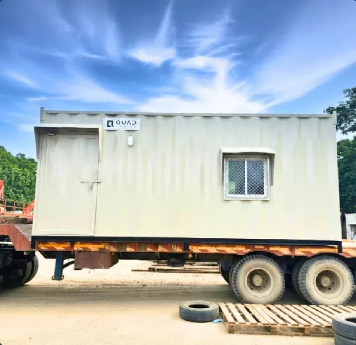 Quad Cabins portable cabin loaded on a trailer for site delivery