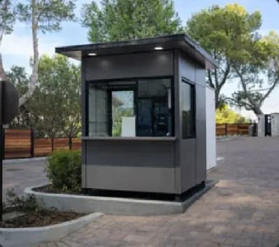 Grey Quad Cabins security cabin installed beside a roadway